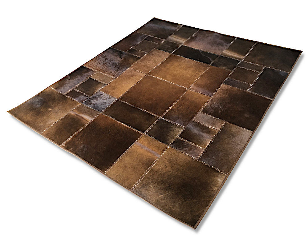 A rectangular patchwork rug made from stitched brown leather or faux-leather panels in varying shades of dark and medium brown, shown at an angle on a plain white background.