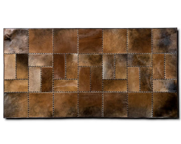 A rectangular patchwork leather rug featuring a mosaic of stitched brown and tan leather panels in various textures and tones, shown against a plain white background.