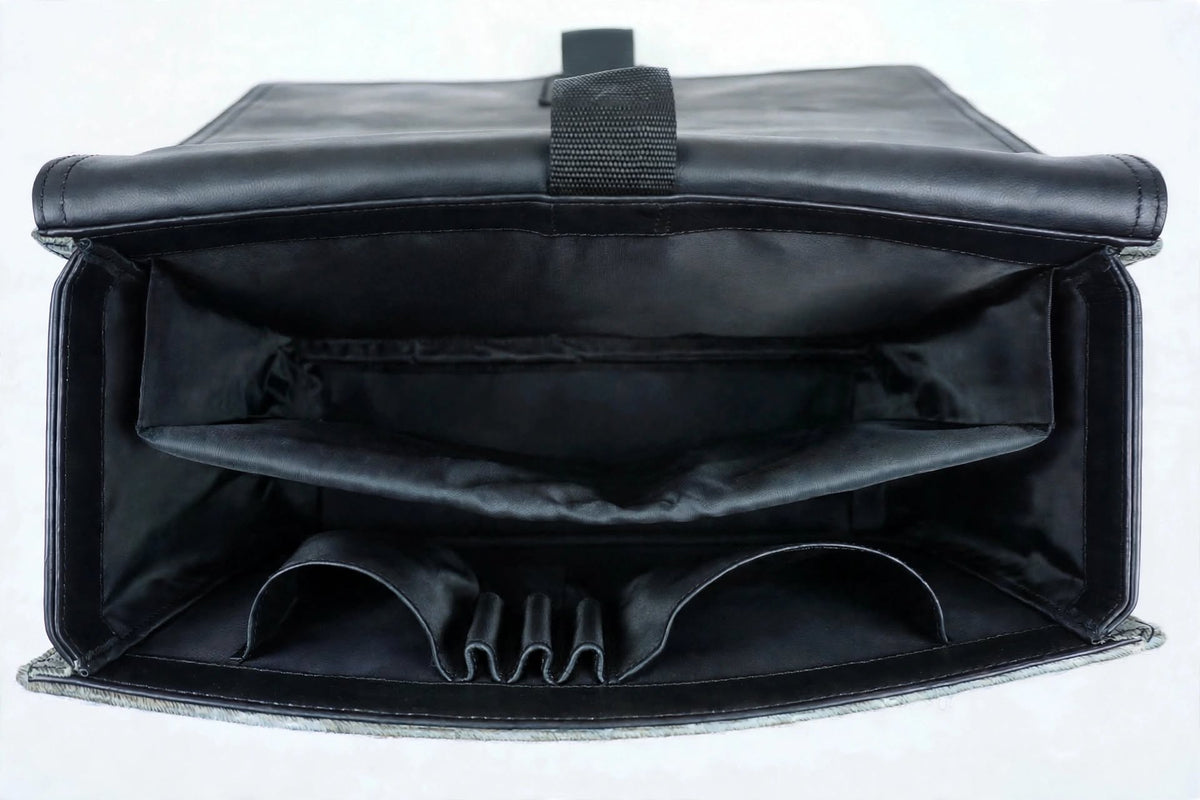 Inside view of cowhide messenger bag showing fabric lining and zip pockets open