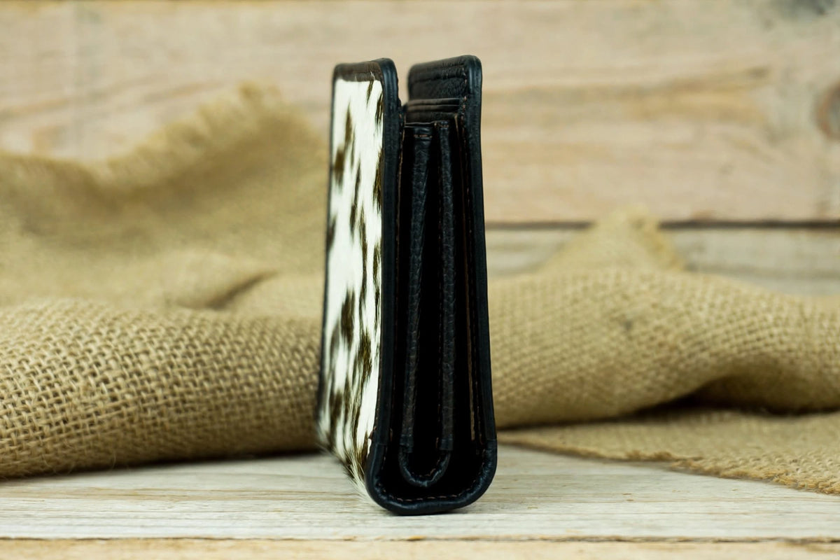 Side Profile View: Side profile of a compact cowhide leather bifold wallet showing its slim design and layered leather construction.