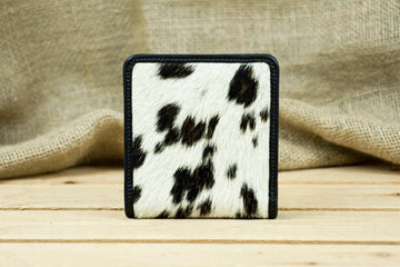 1. Front View: Genuine leather cowhide bifold wallet with natural black and white hide pattern and black leather edging.