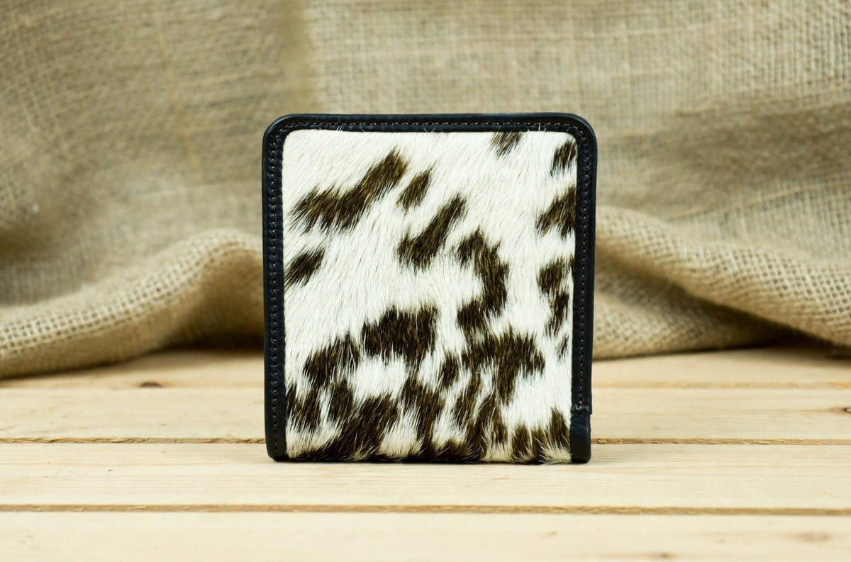 Back View: Back view of a genuine leather cowhide wallet featuring natural hair-on-hide texture and detailed leather stitching.
