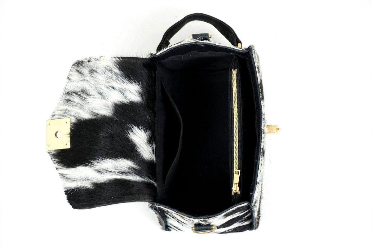 Inside view of cowhide satchel bag showing spacious interior with zip pocket